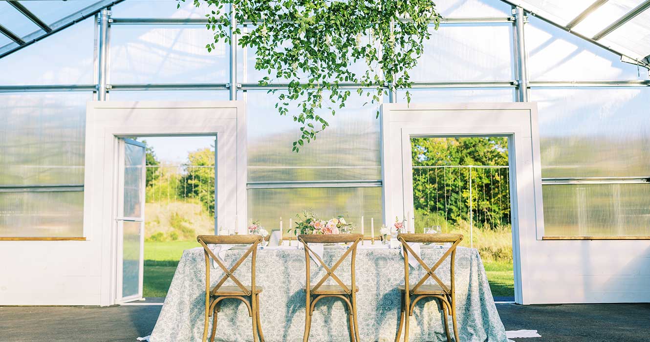 Dining table inside clear wedding tent
